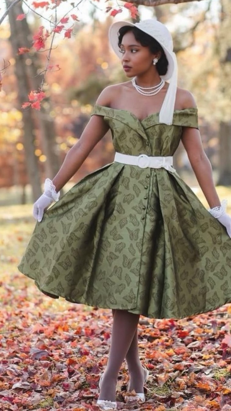 Green butterfly-print off-shoulder dress in a park