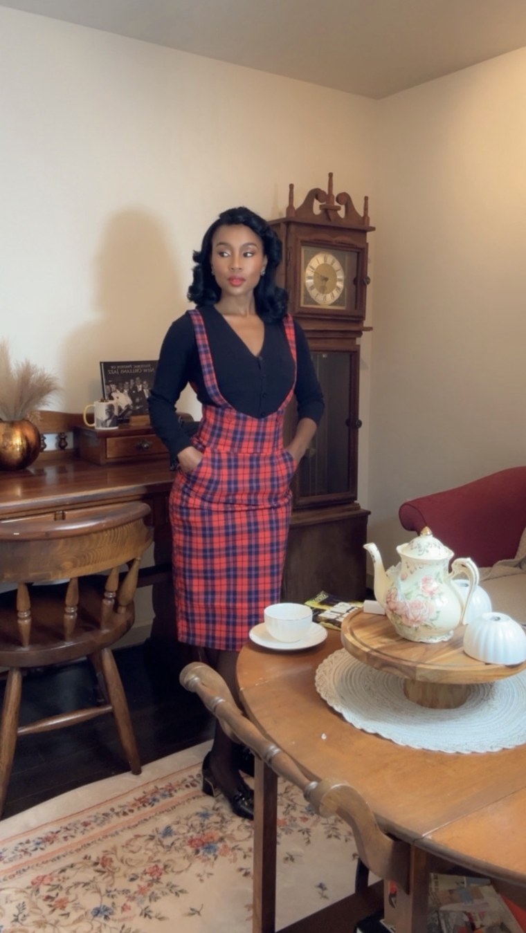 Red tartan pinafore at a tea table